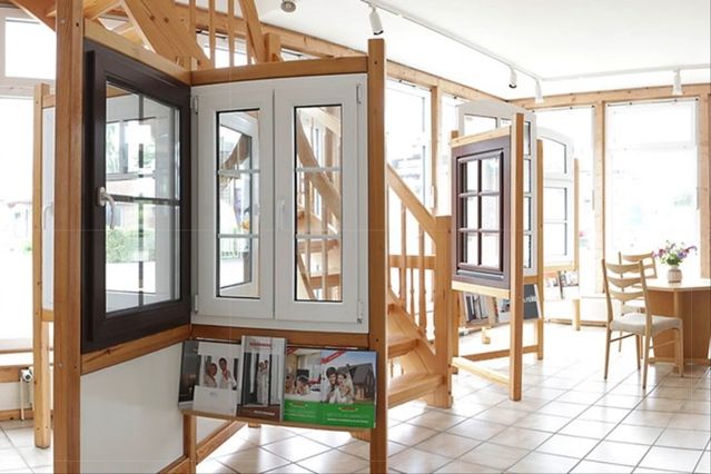 Ein Raum mit einer Holztreppe und einem Fenster, das natürliches Licht hereinlässt.